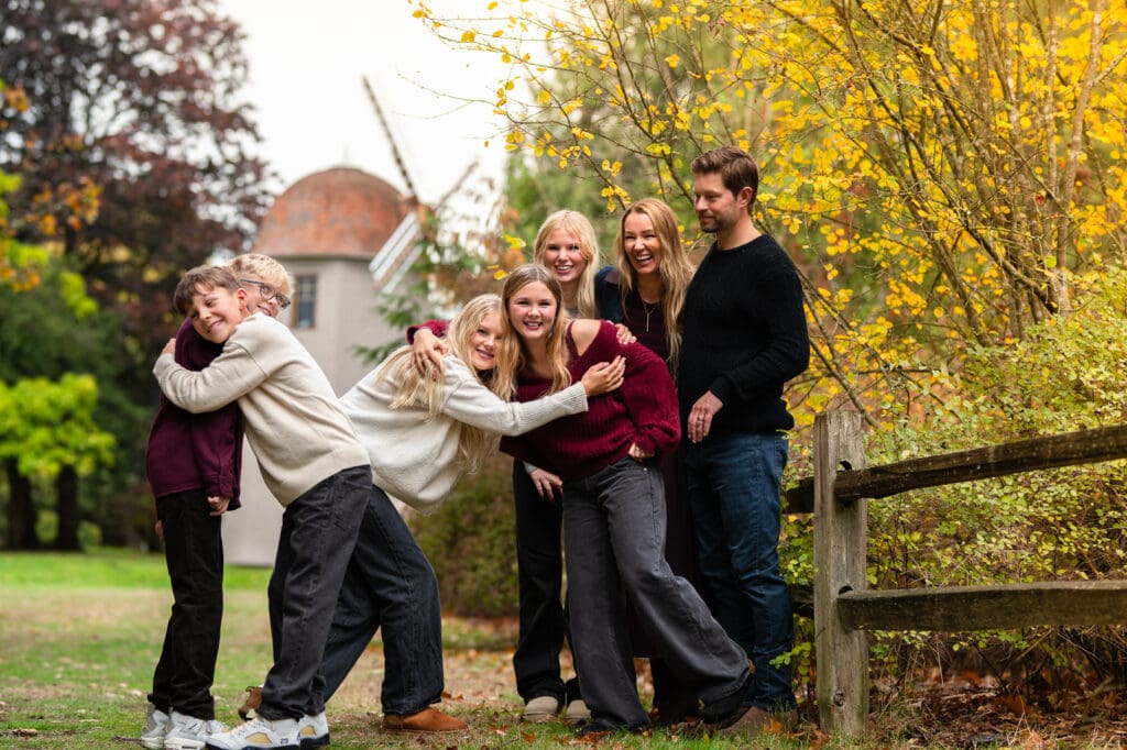 Family photograph showing children embracing each other in a joyful family moment during their photoshoot session.